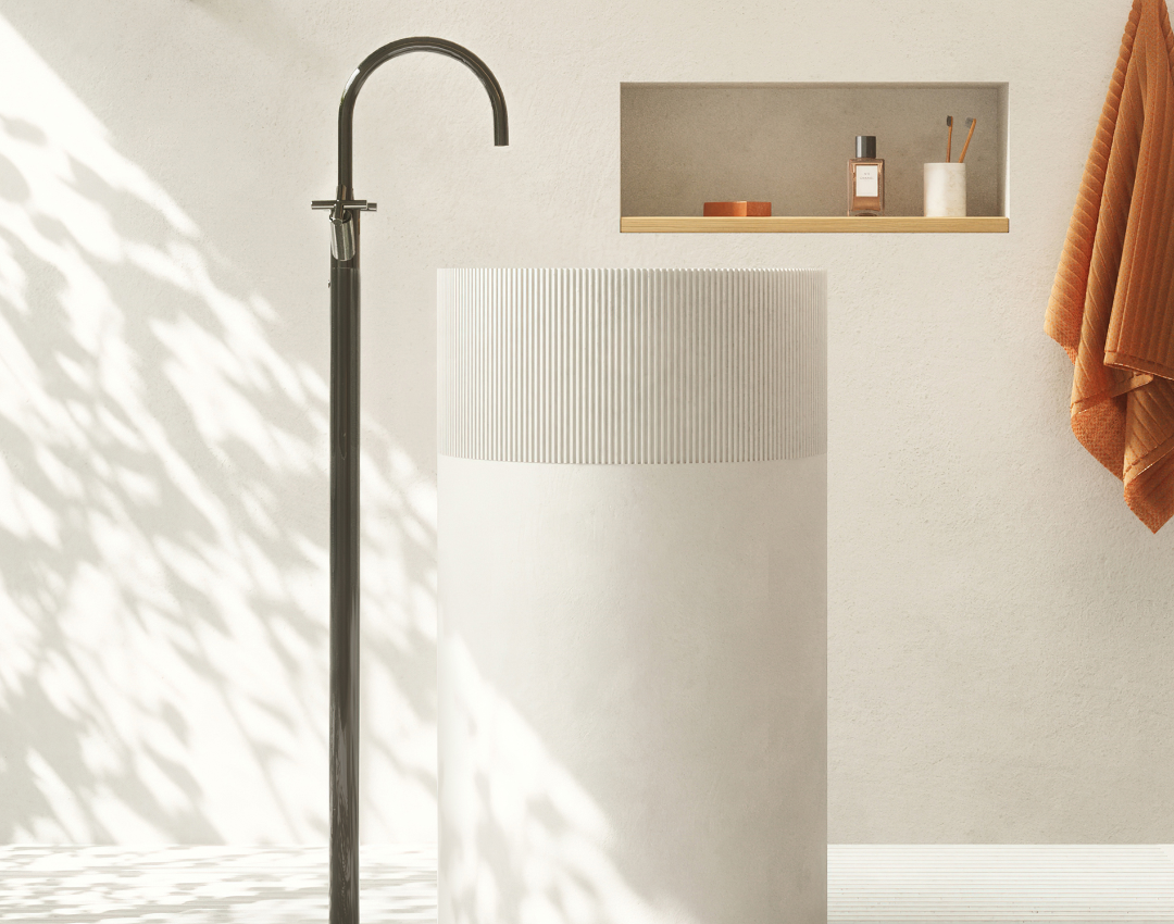 Dornbracht MEM floor-standing black matte basin mixer with a high-arched spout, paired with a white fluted pedestal washbasin.