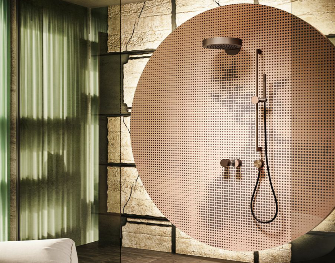 Gessi designer shower system with thermostatic controls and dual shower heads. Modern luxury bathroom featuring a perforated glass partition, textured stone wall, and industrial-style dark brassware.