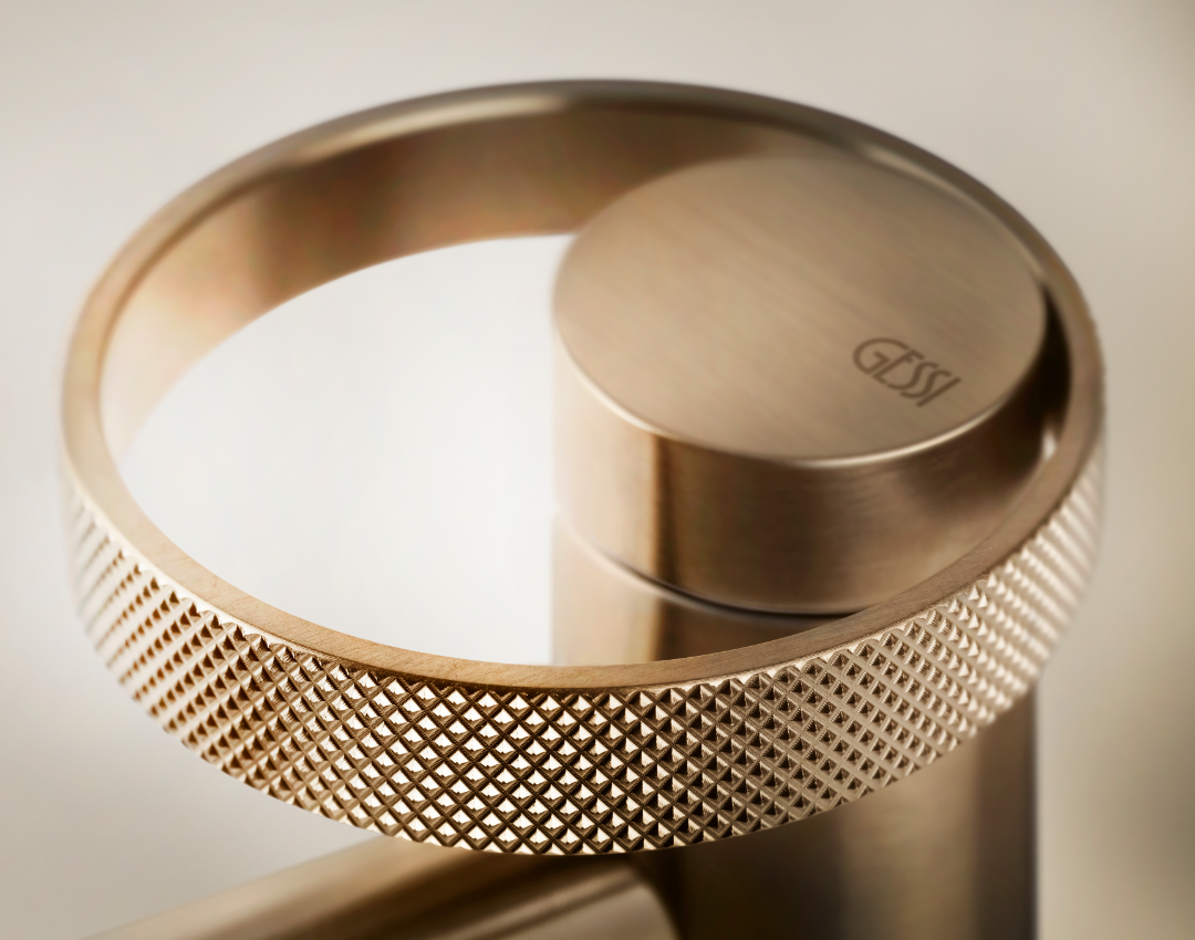 Gessi Anello brushed bronze basin mixer with decorative knurled ring handle. Luxury Italian bathroom brassware featuring a diamond-cut textured finish.