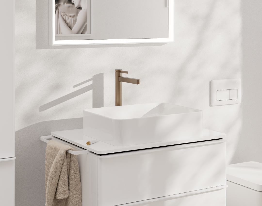 Modern white vanity unit with countertop washbasin and brushed bronze mono basin mixer. Minimalist bathroom furniture featuring a white dual flush plate and designer bathroom lighting.