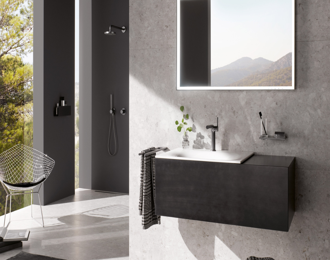 KEUCO modern bathroom with IXMO matte black shower fittings, floating vanity unit, and illuminated LED mirror against terrazzo wall