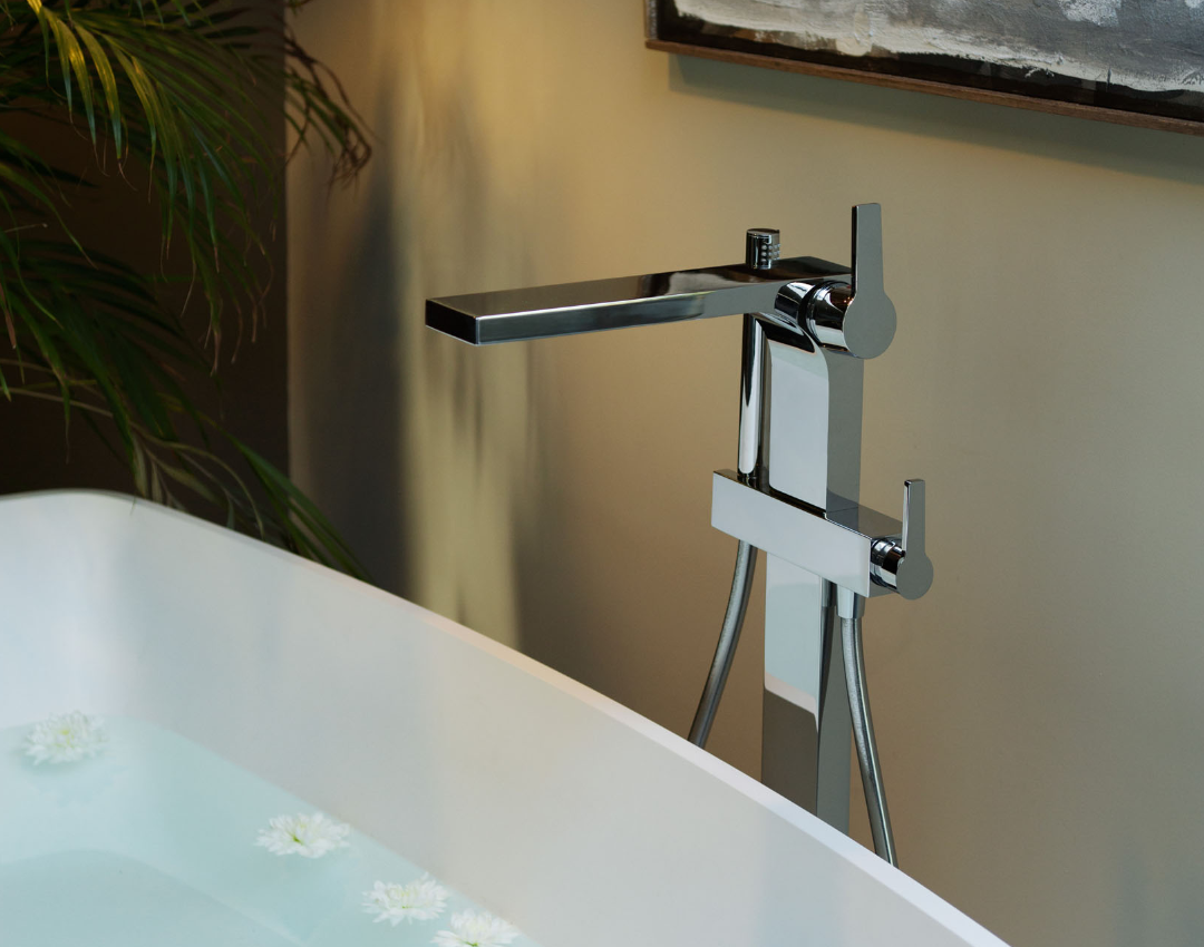 Keuco Edition 400 floor-standing chrome bath mixer tap with hand shower, positioned next to a white freestanding bathtub.